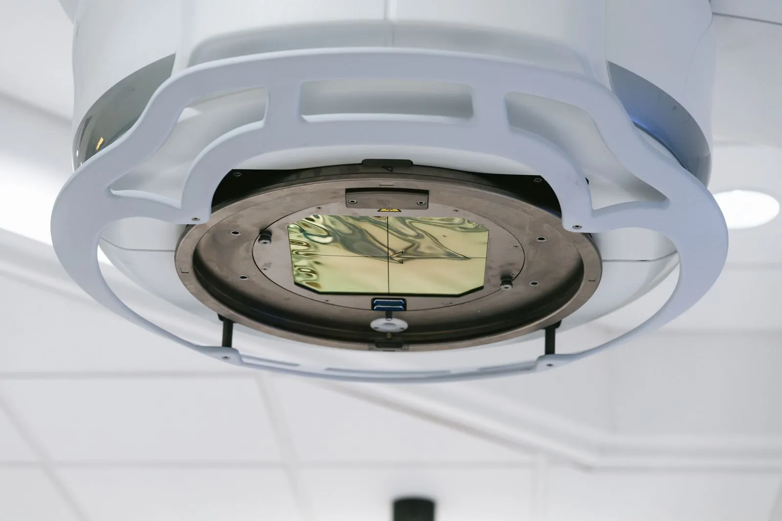 Close-up of a white modern medical imaging gantry head in a bright room